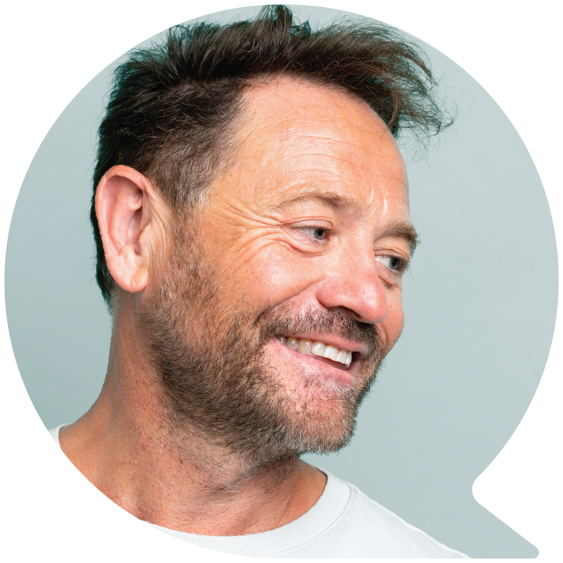 Image of a middle aged man smiling from inside a speech bubble